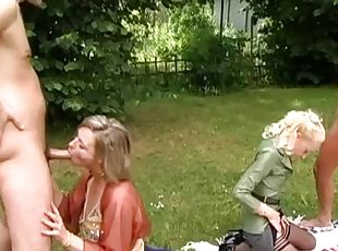 Outdoor foursome with dressed sexy women