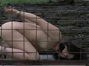 Outdoor BDSM for Enema locked in a tiny cage