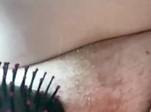 close up of bbw brushing growing bush hairs