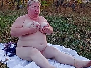Woman masturbates with toys in nature and squirts close-up