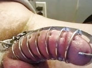 Locked in a metal spiked chastity cage