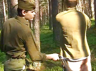 Outdoor spanking scene with two soldiers