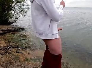 the guy jerks off his big beautiful dick by the lake